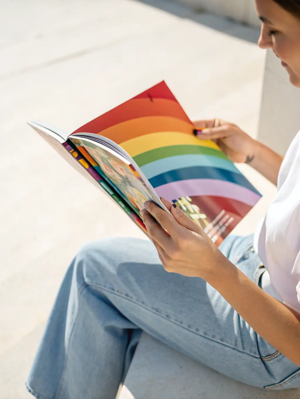 A high-angle, close-up shot of the latest issue of Hollywood Weekly Magazine, showcasing a celebrity on the cover, with a blurred, luxurious Hollywood backdrop.